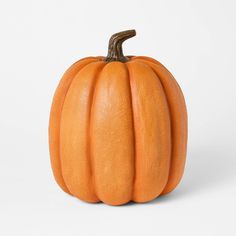 an orange pumpkin sitting on top of a white table