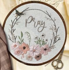 a cross stitch pattern with the words pray surrounded by flowers