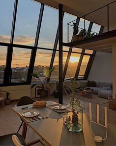 the dining table is set in front of large windows