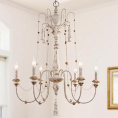 a chandelier hanging from the ceiling in a room