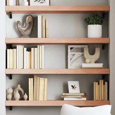 the bookshelf is filled with many different types of books and vases on it