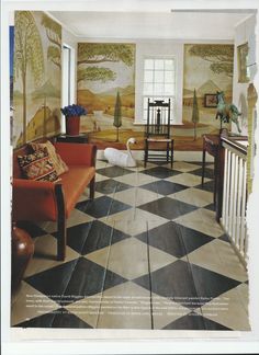 a room with checkered flooring and paintings on the walls