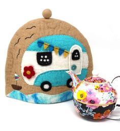 a small tea pot next to a stuffed toy camper