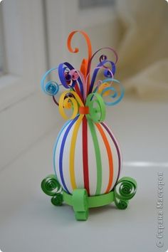 a small colorful vase sitting on top of a table