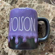 a purple and black coffee mug with the word rosion painted on it