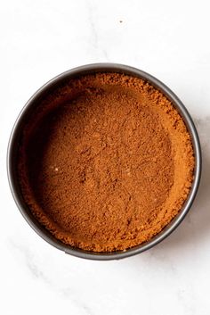 a bowl filled with red powder on top of a white counter