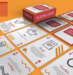 playing cards are laid out on an orange surface with red and white lettering that reads, play card