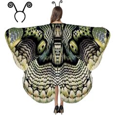 a woman is standing with her back to the camera, wearing a butterfly wings cape