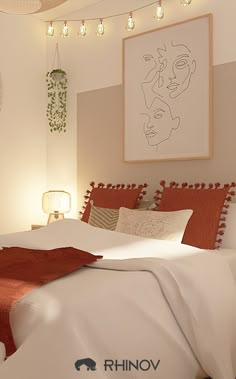 a bedroom with a bed, lamps and pictures hanging on the wall above it's headboard