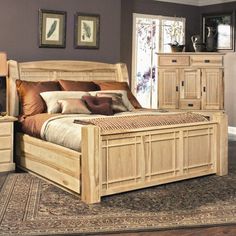 a bed room with a neatly made bed and dressers