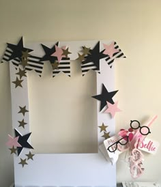 a photo frame made out of paper with stars on it and some decorations around the edges