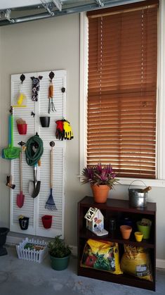 there is a shelf with gardening utensils on it