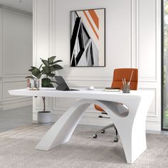 an office desk with a laptop on it in front of a painting and potted plant