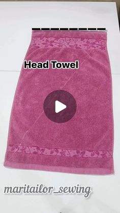 a pink towel with the word head towel on it and an image of a video