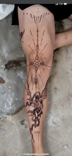 a woman's legs with tattoos on them and the bottom half of her leg