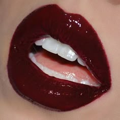 a woman's lips with shiny red lipstick