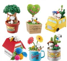 there are many small toy animals in the potted plants and flowers on this white background