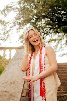 a woman standing on some steps wearing a red and white scarf