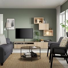 a living room filled with furniture and a flat screen tv on top of a wall