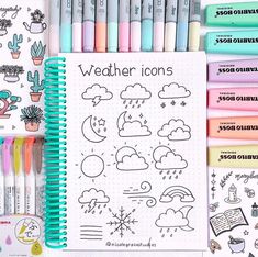 a notebook with markers, pens and stickers on it