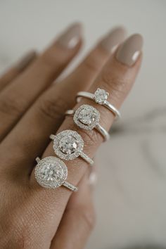 a woman's hand with three different rings on it