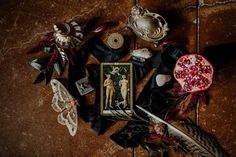 an assortment of items are laid out on the floor next to some feathers and other things