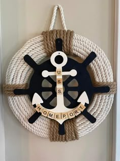 an anchor, wheel and rope hang on the wall