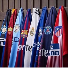 many different soccer jerseys hanging on a wall