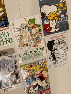 several posters are hanging on the wall next to each other