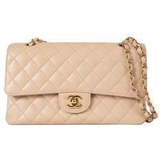 This 100% authentic Chanel Classic Medium 11.12 double flap shoulder bag is crafted from beige quilted Caviar leather with gold-tone hardware. It features an open outside pocket on the back and a classic double chain strap interlaced with leather. The bag opens with the iconic CC turnlock, followed by a second flap with a snap-button closure. The outter flap includes a discreet zipper pocket, traditionally known for storing love letters. The interior is lined in beige leather and includes a lipstick pocket and two open pockets against the back, offering both elegance and practicality. Has been carried and is in excellent condition. Measurements Model ChanelREV A01112 Y01864 21209 Height 16cm (6.2in) Width 25.5cm (9.9in) Depth 6.5cm (2.5in) Drop of the Handle 24cm (9.4in) Shoulder Strap Len Chanel Classic Medium, Chanel Beige, Double Chain, Flap Bag, Fashion Handbags, Chain Strap, Chanel Classic, Bags Handbags, Leather Bag