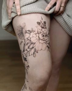 a woman's thigh with flowers on it