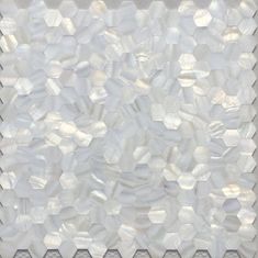 white marble mosaic tile with hexagonal design on the bottom and sides, in an irregular