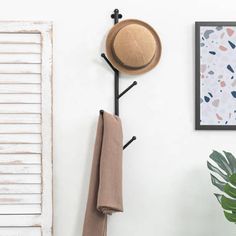 a coat rack and hat hanger on the wall