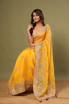 Look royal in this gorgeous mango yellow embroidered organza saree on festive occasions! It comes with a blouse piece. Disclaimer: The actual product may vary slightly from the image. These are custom orders, hence expect slight variation in color, placement of the motif or buta. ESTIMATED DELIVERYBecause this is a custom order, it would take about 4 weeks from the date of purchase. RETURN POLICYThis product is a custom order and cannot be returned or exchanged. Fashion Journals, Organza Saree, Traditional Fabric, Handloom Saree, Sarees Online, Blouse Piece, Saree Wedding, Blouse Dress, Fashion Store