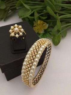 Material:  brass, CZ Stones. Suitable for all kind of outfits like Kurtis lehanga Sarees and Trousers. Arrives in a small plastic box. Highest quality of Craftsmanship. Please let me know if you any questions. Bracelet  1 Ring 1 Lehanga Saree, Jewellery Traditional, Pearl Bangles, Jewelry Victorian, Sabyasachi Jewellery, Bracelet Pearl, Pearl Bangle, Bangles Indian, Traditional Jewelry