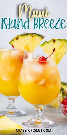 two glasses filled with liquid and topped with pineapple