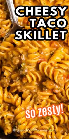 a skillet filled with cheesy taco skillet pasta next to a spoon