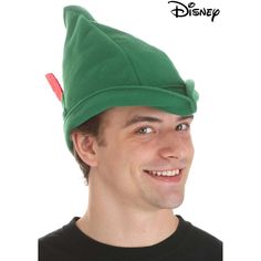 a man wearing a green elf hat and smiling at the camera with his eyes closed