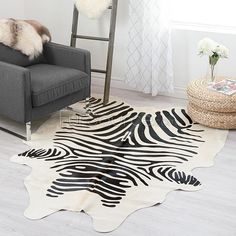 a zebra print rug on the floor in a living room with a ladder and chair