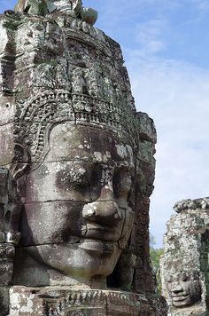 the face of an ancient stone statue at bayon temple in angor, cambodia