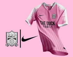 a pink soccer jersey with the words the duck family on it next to a black and white crest