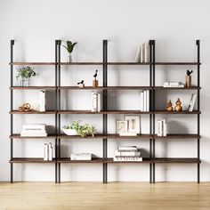 a bookshelf with many different types of books on it in an empty room