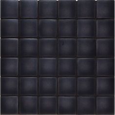 a black tile wall with square tiles on the bottom and one side, in different sizes