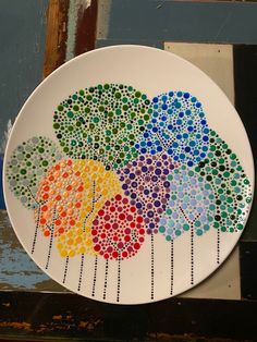 a white plate with multicolored trees on it