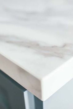 a white marble counter top in a kitchen