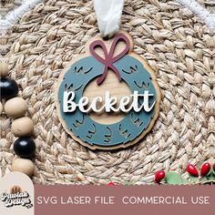 a wooden ornament with the word beckt on it and a ribbon hanging from it