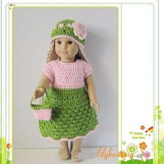 a crocheted doll wearing a green dress and pink hat