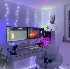 a computer desk with two monitors on top of it and a chair in front of the monitor