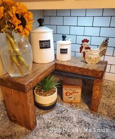 a kitchen counter with flowers and containers on it