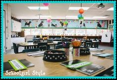 an empty classroom with desks and books on the table in front of it is decorated with colorful decorations